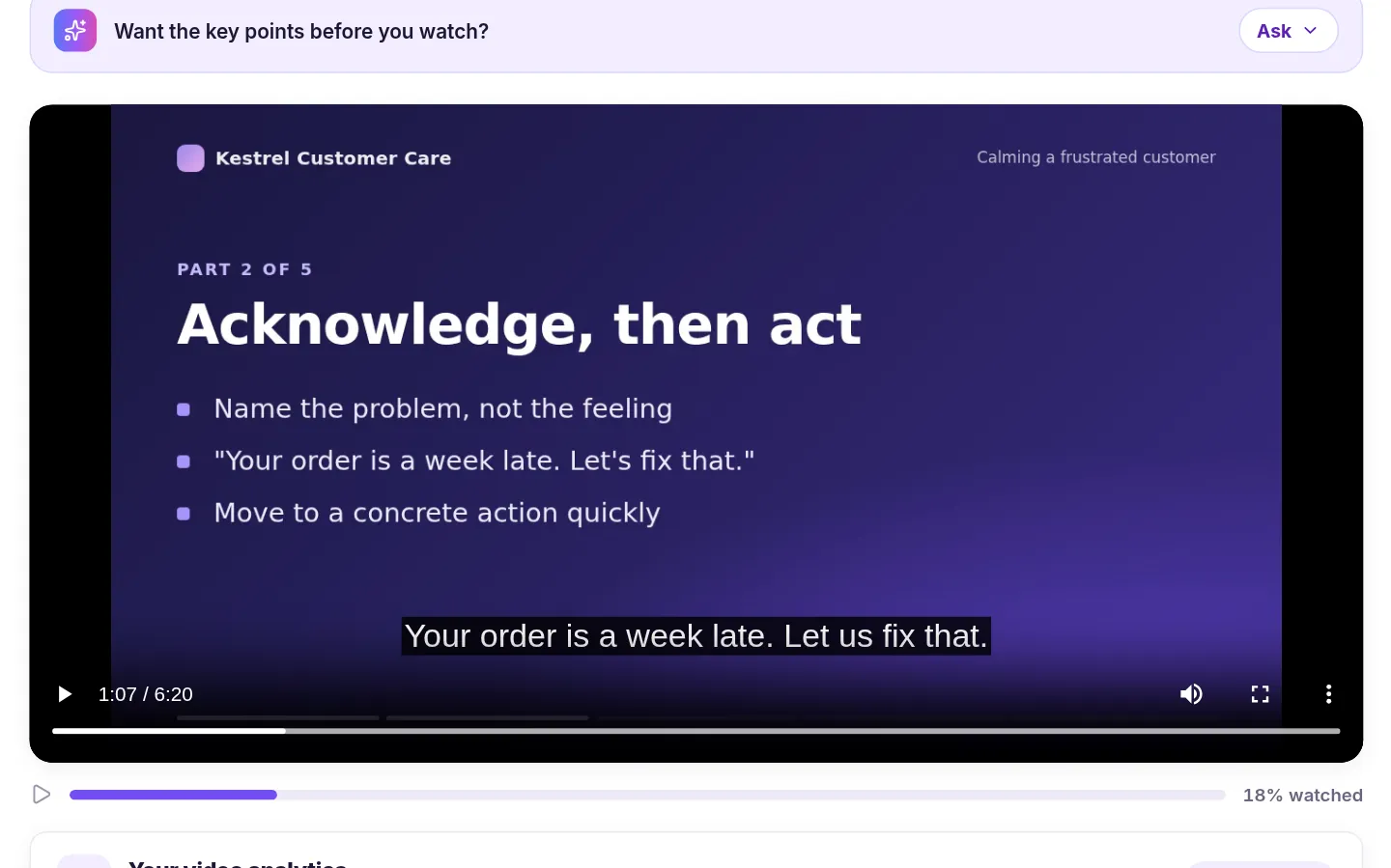 Close-up of the video player at 1:07 of 6:20 on a slide titled Acknowledge, then act, with the caption Your order is a week late. Let us fix that. shown at the bottom of the video, and the Want the key points before you watch? prompt above it.